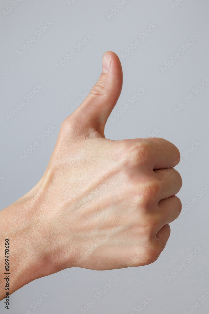 Gesture and sign, male hand on a white background. Hand good. Good job Gesture and sign, male hand on a white background. Hand good. Good job