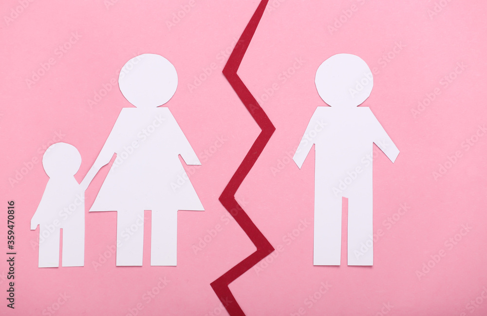 Broken family, divorce. Deprivation of parental rights. Split paper family on pink background Broken family, divorce. Deprivation of parental rights. Split paper family on pink background