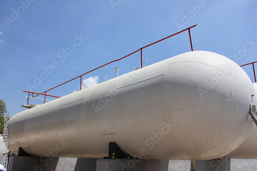 A pressure vessel constructed of a horizontal steel cylinder (LPG Storage, In the United States ASME Boiler and Pressure Vessel Code, Ad Merkblatt design). Pressure must be built to a formal code.