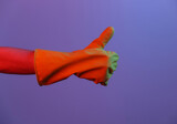 Female hand in latex glove shows thumb up. Gradient neon light