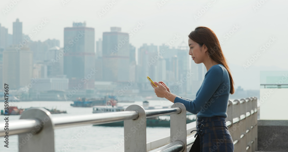 Woman send message on cellphone in city Woman send message on cellphone in city
