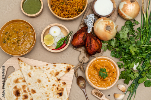 Various indian food menus, biryani rice, butter chicken, tandoori, bean curry and naan bread