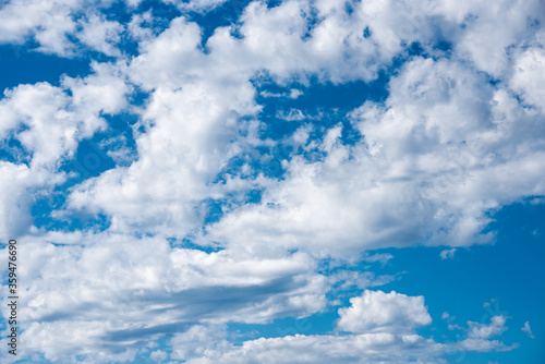 Fototapeta Naklejka Na Ścianę i Meble -  White heap clouds in the blue sky. Cloudscape over horizon. Heaven