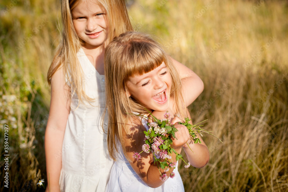 Two little friends hug and laugh merrily Two little friends hug and laugh merrily