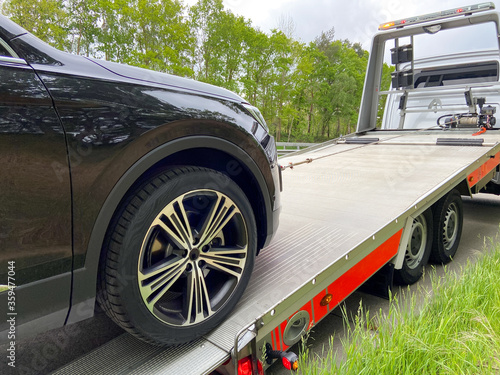 Wallpaper Mural Black new SUV is pulled onto a tow truck Torontodigital.ca
