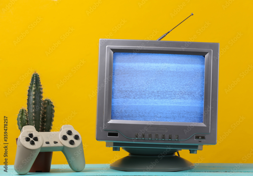 Antenna old-fashioned retro tv receiver with gamepad, cactus on yellow background. Retro entertainment 80s