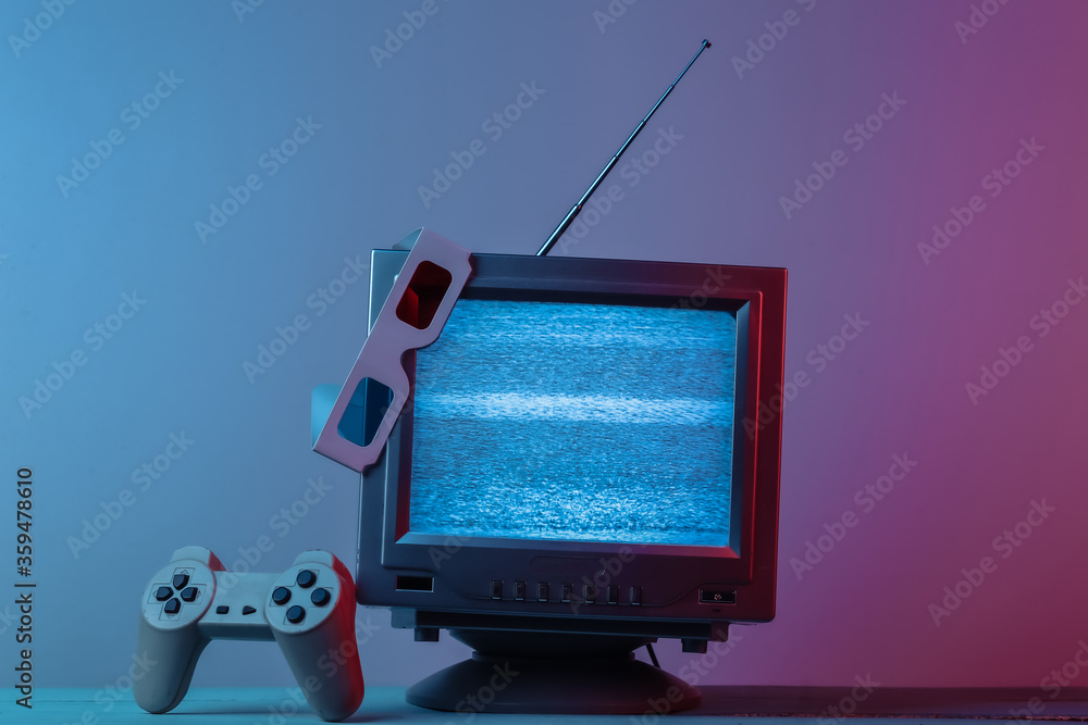 Antenna old-fashioned  tv receiver with anaglyph stereo glasses, gamepad in pink blue gradient neon light. Retro media, entertainment 80s, retro wave