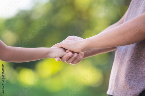 hand hold mom Concept Love the giver Of mothers with children On blurred background nature  © photosky99