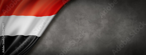 Yemen flag on concrete wall banner photo