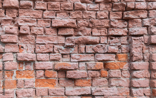 old red brick wall with cracks from time