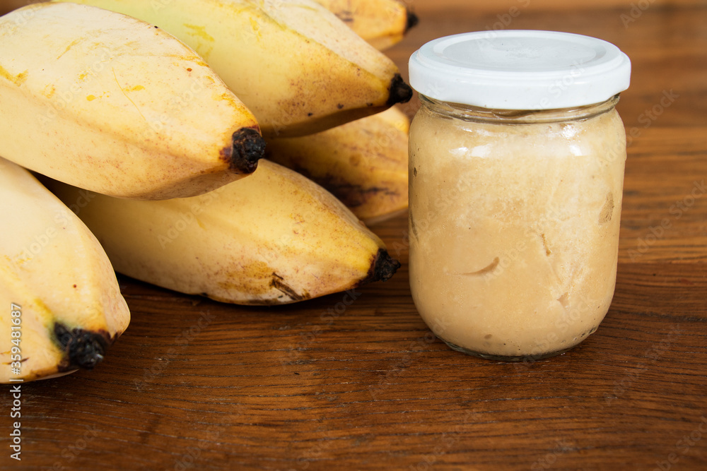 Nutrition concept - Green Banana Biomass in glass jar, good source of fiber, vitamins and minerals, and contains a starch that may help control blood sugar, manage weight and lower blood cholesterol. Nutrition concept - Green Banana Biomass in glass jar, good source of fiber, vitamins and minerals, and contains a starch that may help control blood sugar, manage weight and lower blood cholesterol.