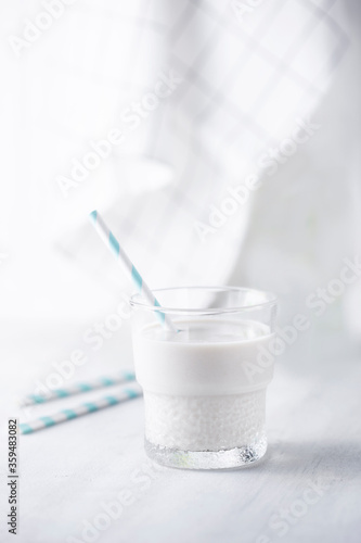 Milk in a glass with paper straw