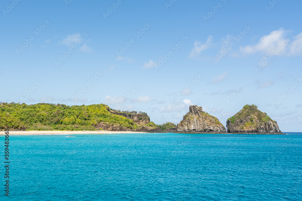 Beautiful background view of Cacimba do Padre beach with Dois Irmaos Hill and turquoise clear water, at Fernando de Noronha, Unesco World Heritage site, Pernambuco, Brazil