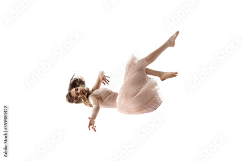 Mid-air beauty cought in moment. Full length shot of attractive young woman hovering in air and keeping eyes closed. Levitating in free falling, lack of gravity. Freedom, emotions, artwork concept.