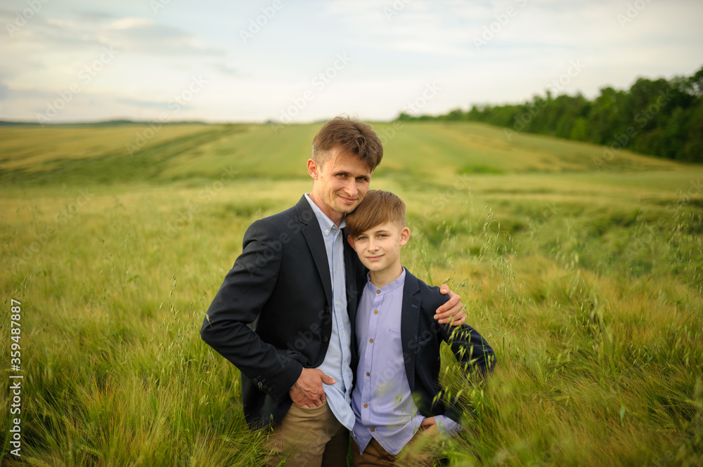 Father and son in a green wheat field Father and son in a green wheat field