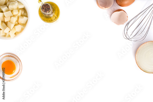 Spanish omelette tortilla ingredients: eggs, potatoes and onion isolated on white background. Top view