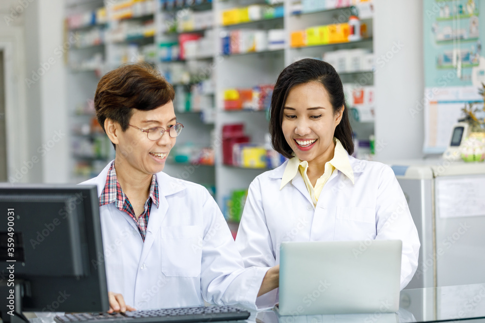 Professional pharmacist working with computer in drugstore Professional pharmacist working with computer in drugstore