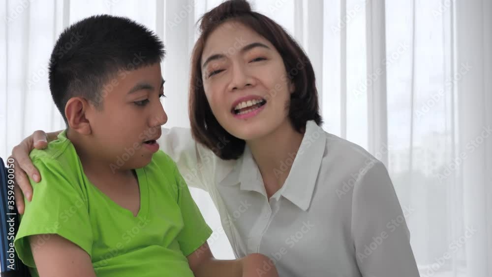 Mother holding hands and hug son disability on wheelchair at home. Slow motion Mother holding hands and hug son disability on wheelchair at home. Slow motion