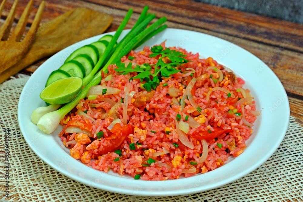 Authentic Thai old style fried rice in red sauce served with spring onion, cucumber slices and lime. Authentic Thai old style fried rice in red sauce served with spring onion, cucumber slices and lime.