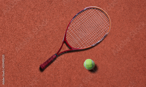 Tennis racket and ball on red court © H.M Abstracts