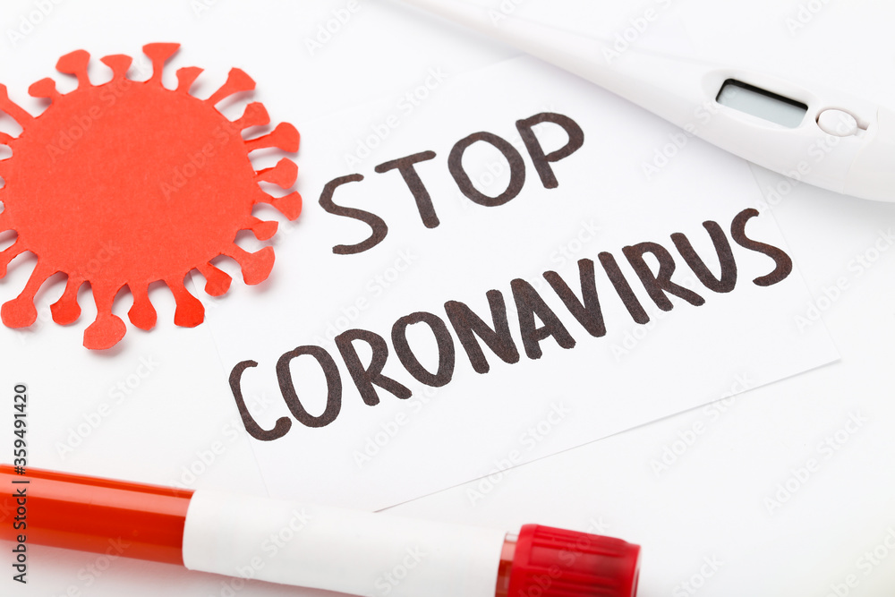 Obraz premium Text Stop Coronovirus with thermometer and test tube on white background