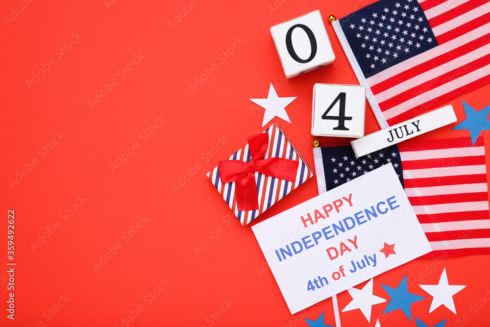 Text Happy Independence Day with flags, gift box and cube calendar on red background Text Happy Independence Day with flags, gift box and cube calendar on red background