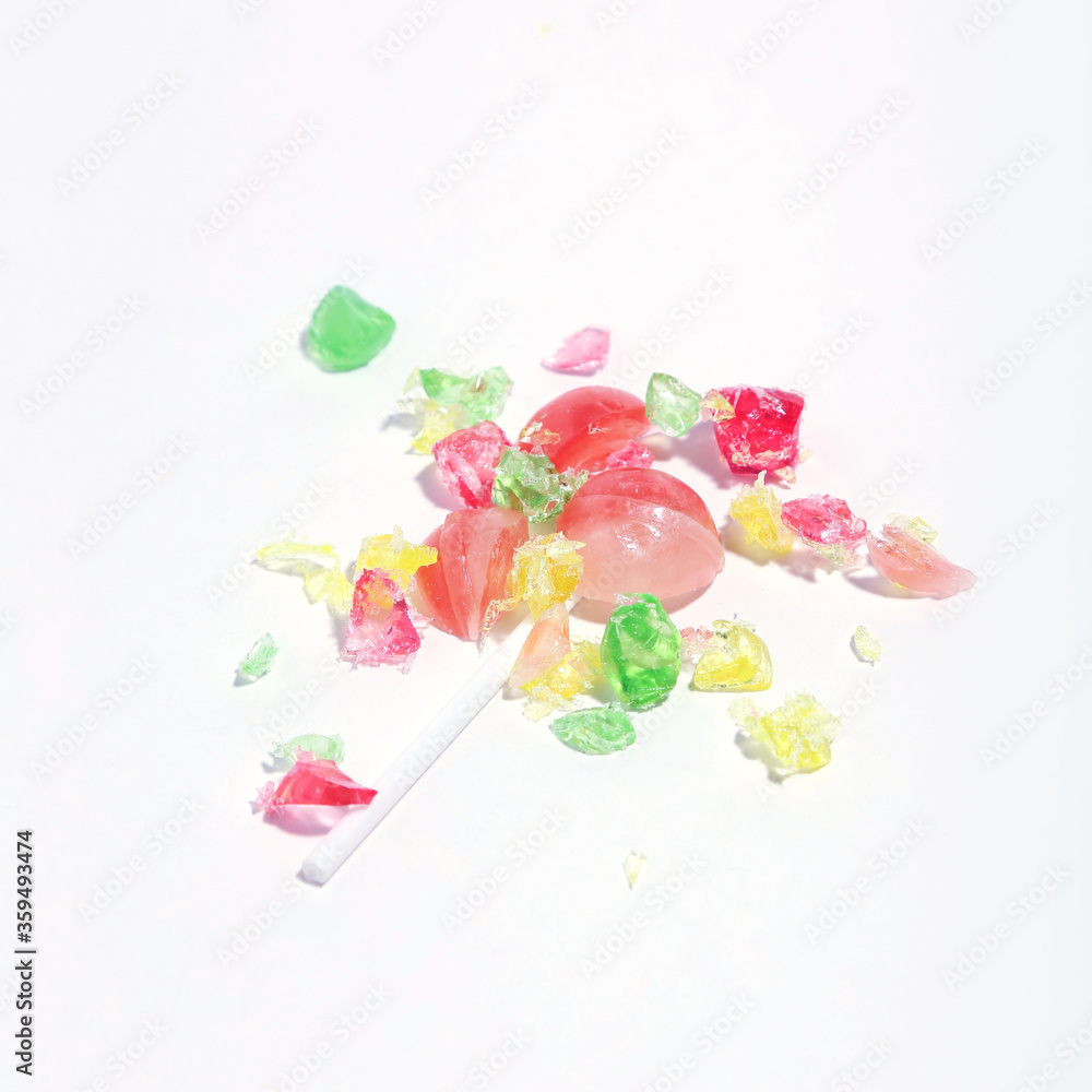 Crumbled candy on white background. Minimalism concept Crumbled candy on white background. Minimalism concept