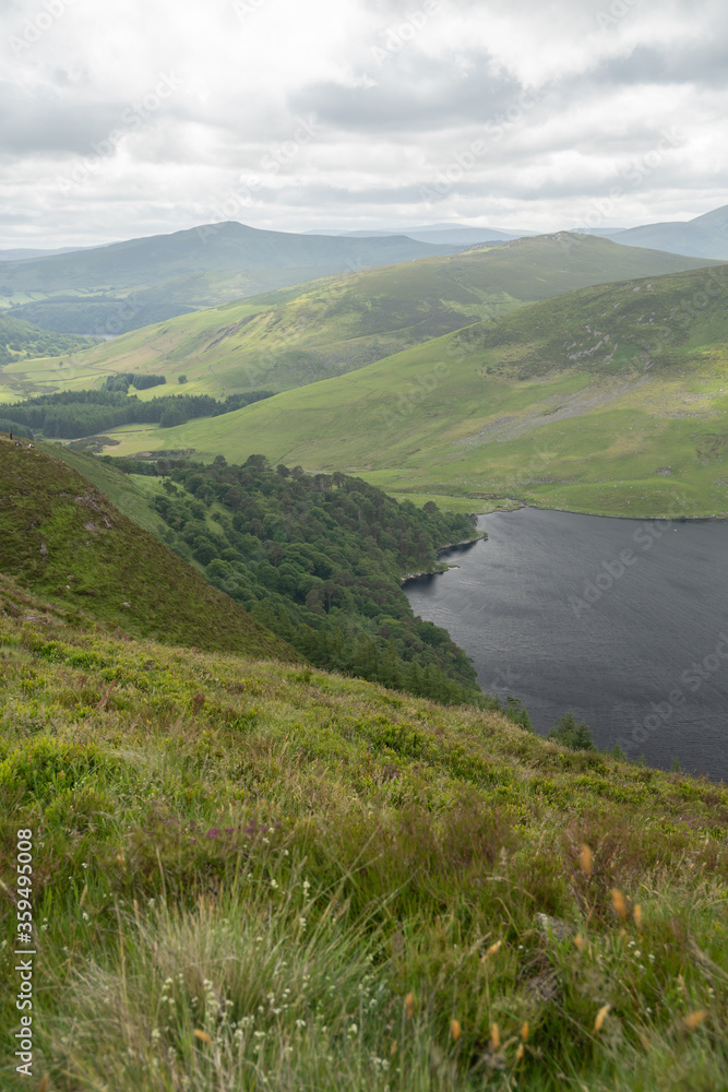 Panoramic view of The Guinness Lake (Lough Tay) - a movie and series location, such as Vikings. Close to Dublin City, popular tourist destination. Panoramic view of The Guinness Lake (Lough Tay) - a movie and series location, such as Vikings. Close to Dublin City, popular tourist destination.
