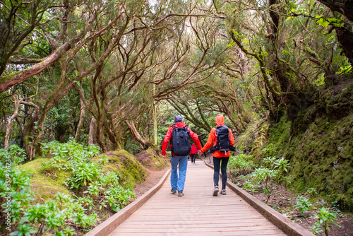 Sporty tourist couple on hiking trail in Anaga Rural Park - ancient rain forest on Tenerife, Canary Islands.