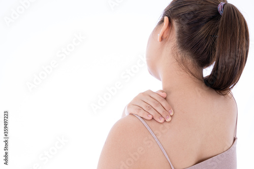 A woman feeling exhausted and suffering from shoulder and neck pain and injury on isolated white background. Health care and medical concept.