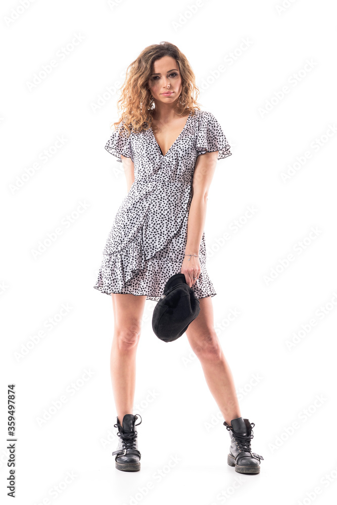 Confident cool attitude young stylish woman removing and holding beret cap looking at camera. Full length portrait isolated on white background. Confident cool attitude young stylish woman removing and holding beret cap looking at camera. Full length portrait isolated on white background.