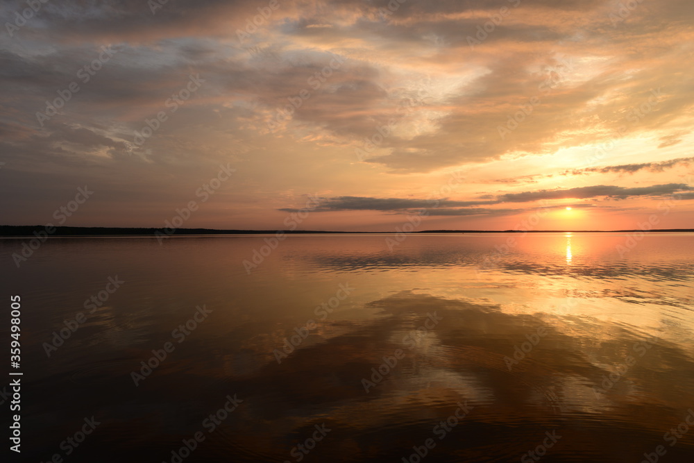 Sunbeam on the mirror water lake at sunset