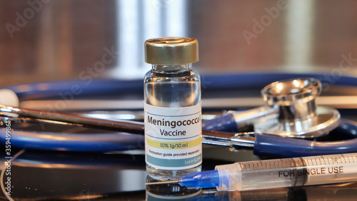 Vial of Meningococcal vaccine whit syring and stethoscope photo