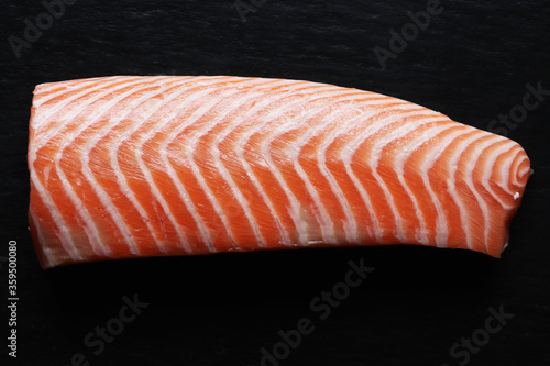 Photography of a peeled salmon back on slate background or food illustrations