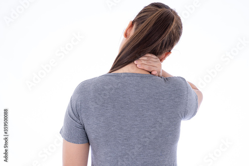 A woman feeling exhausted and suffering from neck pain and injury on isolated white background. Health care and medical concept.