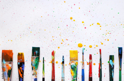 Colorful background of paint brushes in a row 