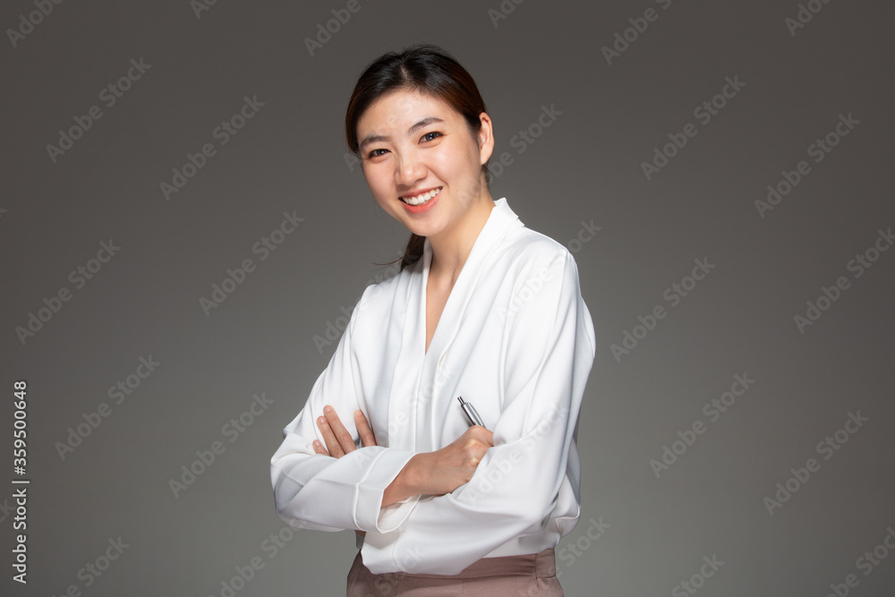 Business Woman smiling on grey background Business Woman smiling on grey background