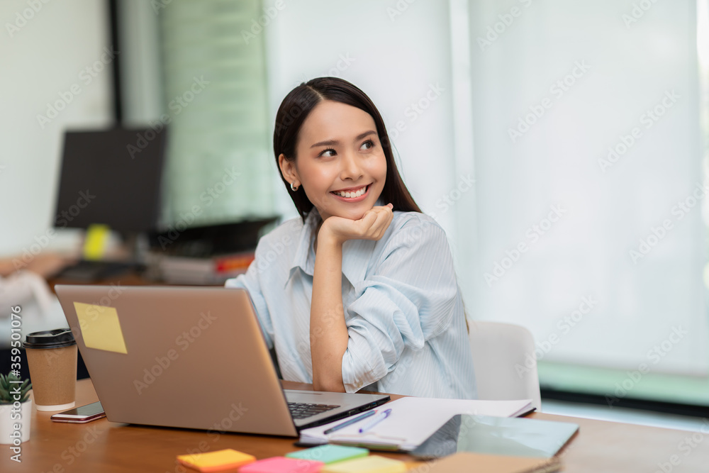 Happy Asian business woman working with laptop and smile Happy Asian business woman working with laptop and smile