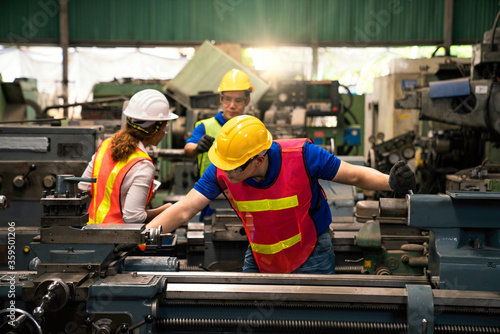 An expert technician is inspecting industrial machinery in a steel factory. Engineers are working and repairing machines in industrial. Technician holding Measuring pliers. © Thirawatana