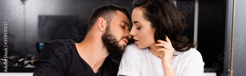 panoramic crop of man and young woman with closed eyes © LIGHTFIELD STUDIOS