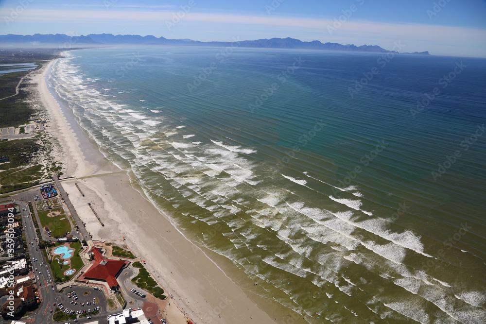 Cape Town, Western Cape / South Africa - 10/03/2016: Aerial photo of Muizenberg Beach with False Bay in the background
