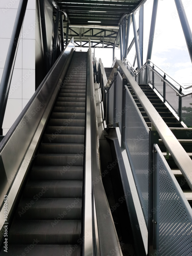 Architecture construction of elevator, escalator stairs and sky walk way, walk bridge between sky train station and department store mall Architecture construction of elevator, escalator stairs and sky walk way, walk bridge between sky train station and department store mall