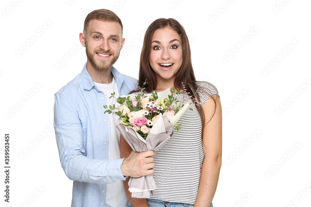 Happy young couple with bouquet of flowers on white background Happy young couple with bouquet of flowers on white background