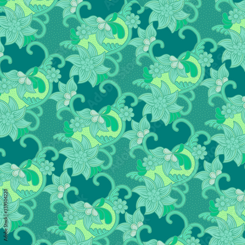 Traditional floral pattern batik drawing with dots and curly lines in turquoise and green tone. Batik is an Indonesian technique of wax-resist dyeing applied to whole cloth.