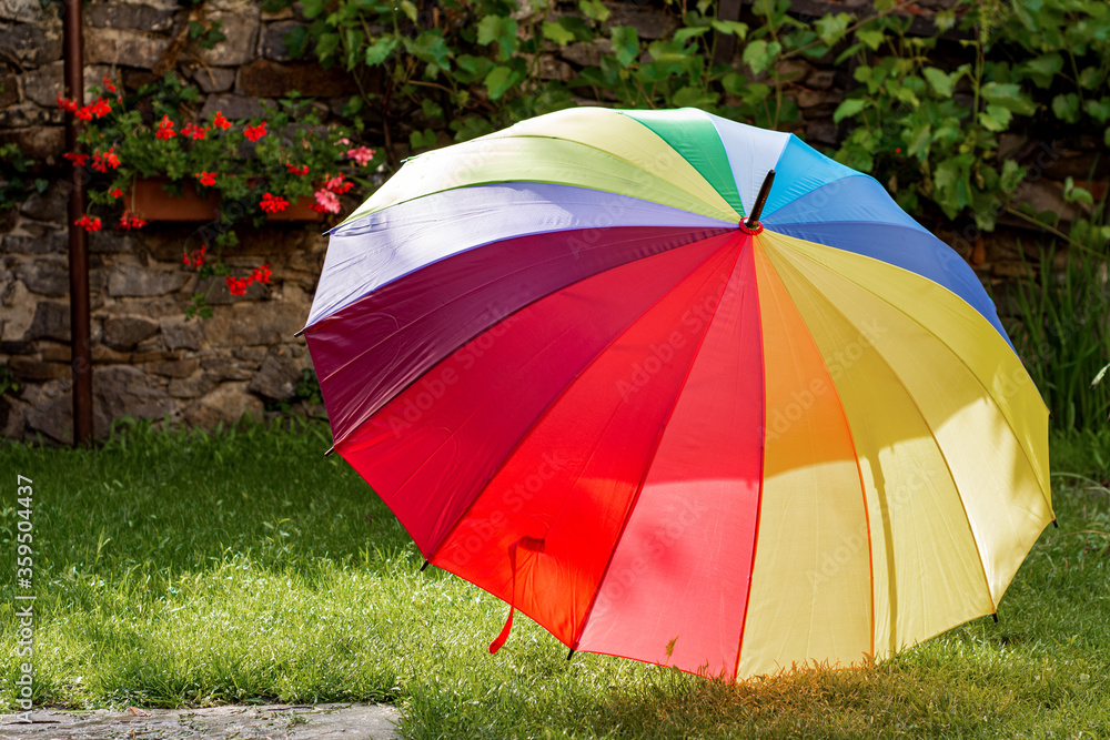  Colorful rainbow open umbrella in the garden