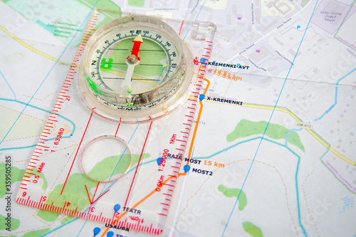 travel sport compass lies on a map to determine azimuth movement