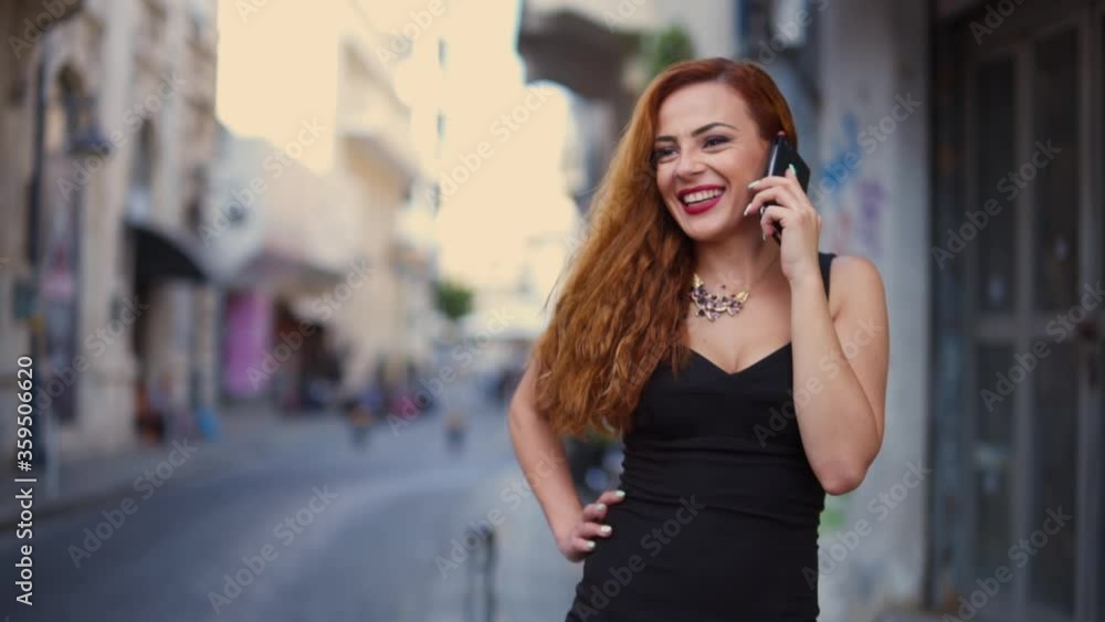 Confident smiling businesswoman talking on mobile phone in city street Confident smiling businesswoman talking on mobile phone in city street