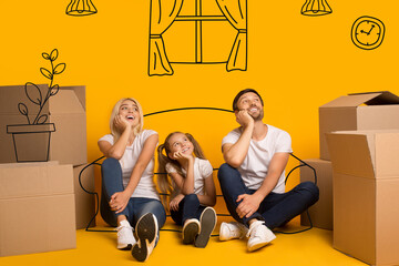 Happy parents and kid with carton boxes imagining their new home on orange background with drawings