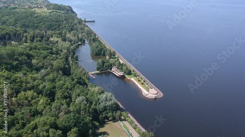 Aerial view. A large exotic wooden ship is located near the shore. Green lagoon. Kiev, Mezhyhirya. Drone