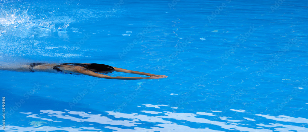 Woman swimming in open air swim pool